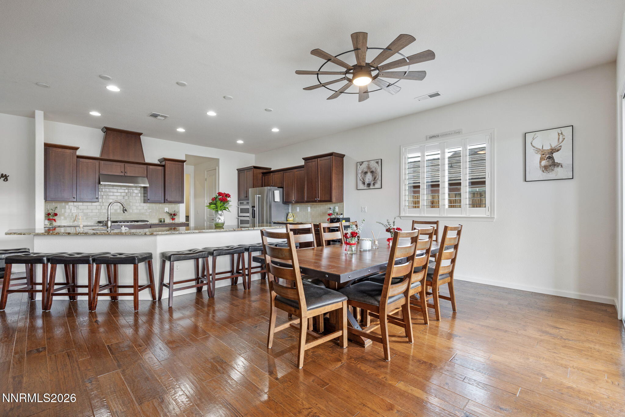 9811 Dyevera Lane Reno, NV 89521 - Photo 12 of 32 a view of a dining room with furniture window and wooden floor