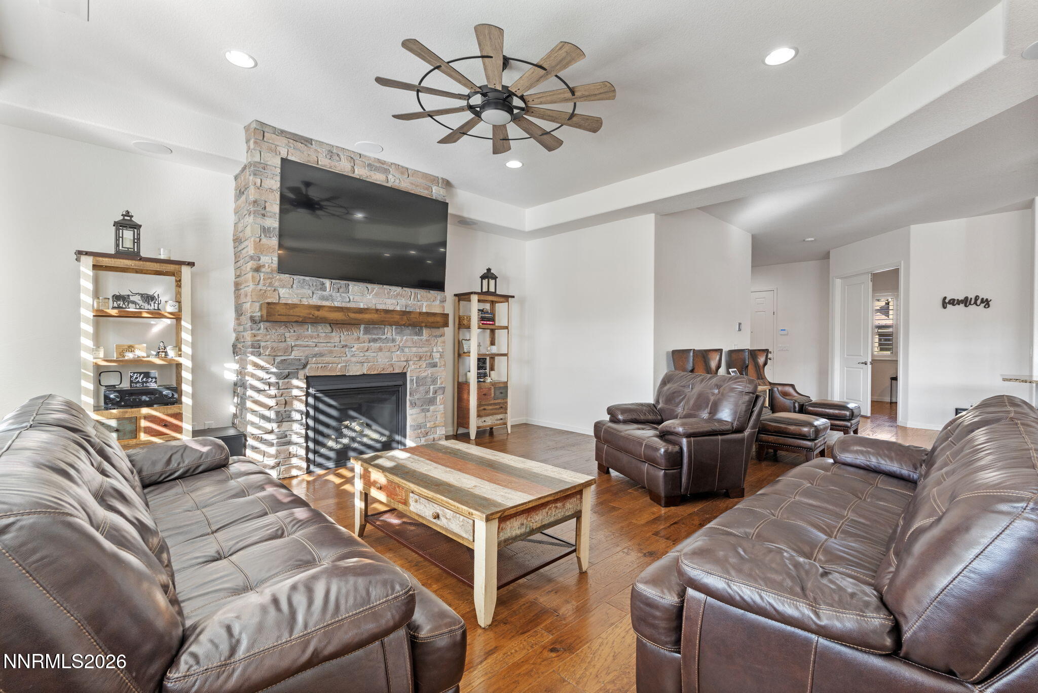 9811 Dyevera Lane Reno, NV 89521 - Photo 13 of 32 a living room with furniture a flat screen tv and a fireplace