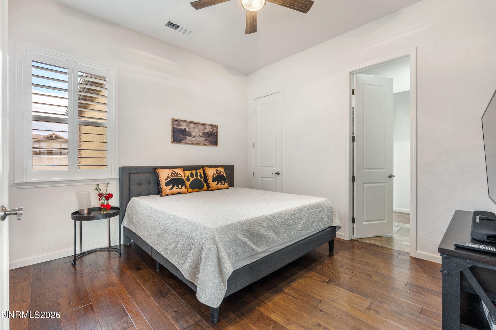 9811 Dyevera Lane Reno, NV 89521 - Photo 19 of 32 a bedroom with a bed and a chandelier