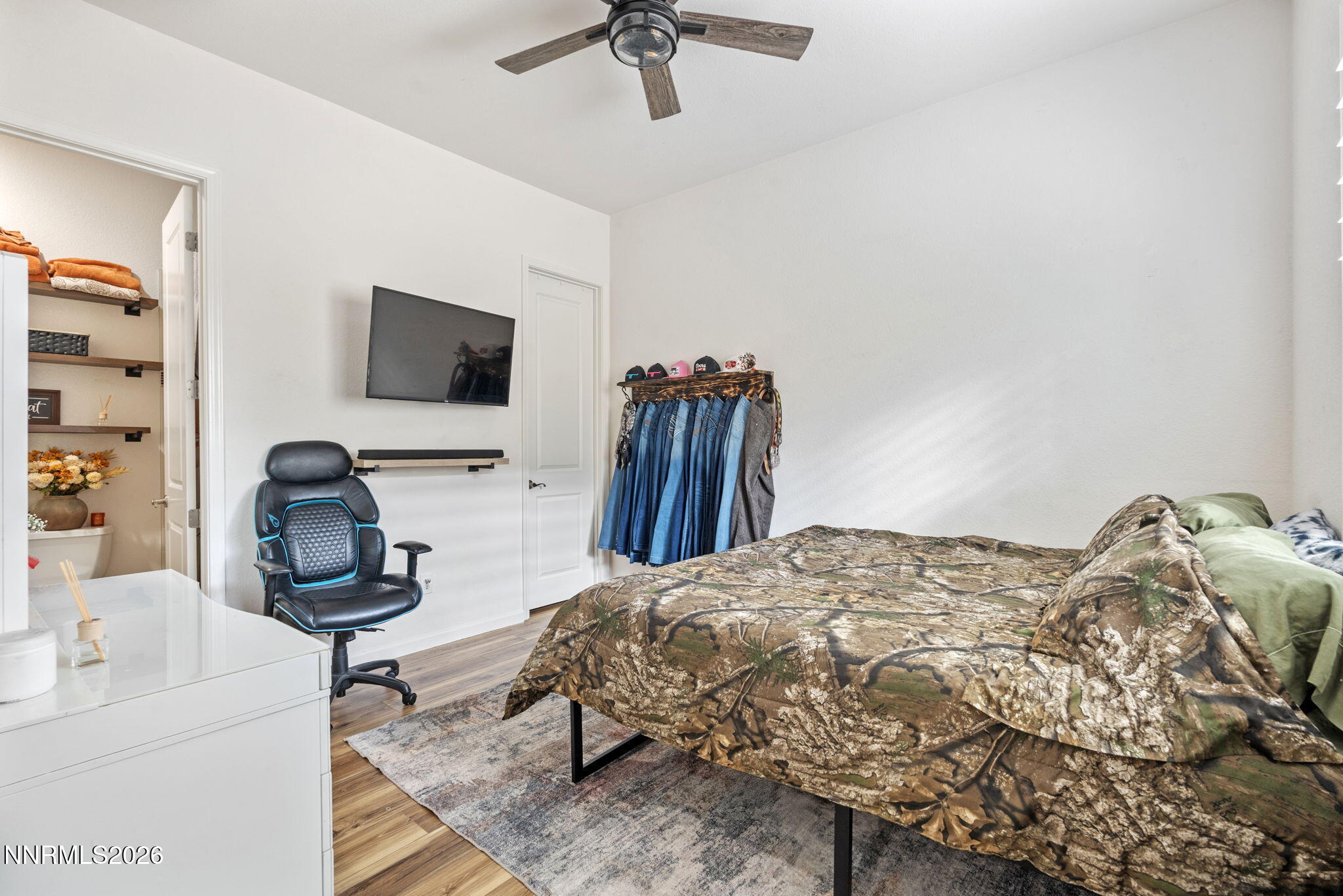 9811 Dyevera Lane Reno, NV 89521 - Photo 21 of 32 a bedroom with a bed and a flat screen tv