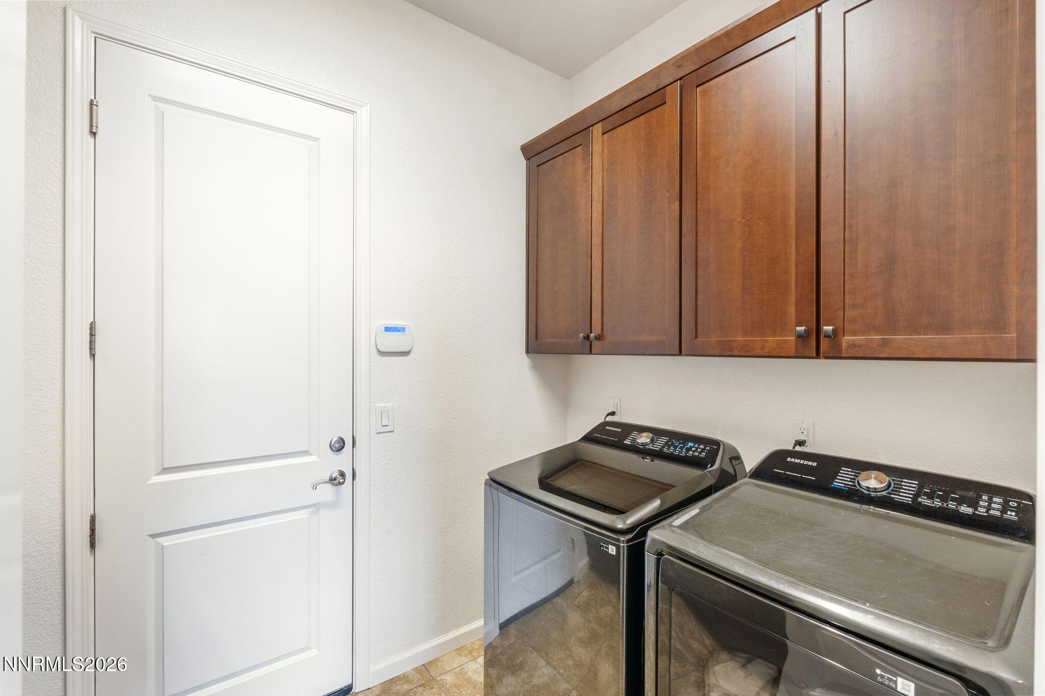 9811 Dyevera Lane Reno, NV 89521 - Photo 25 of 32 a view of a refrigerator and cabinets