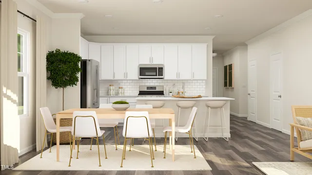 a kitchen with stainless steel appliances kitchen island granite countertop a refrigerator a stove a microwave oven a dining table and chairs with wooden floor
