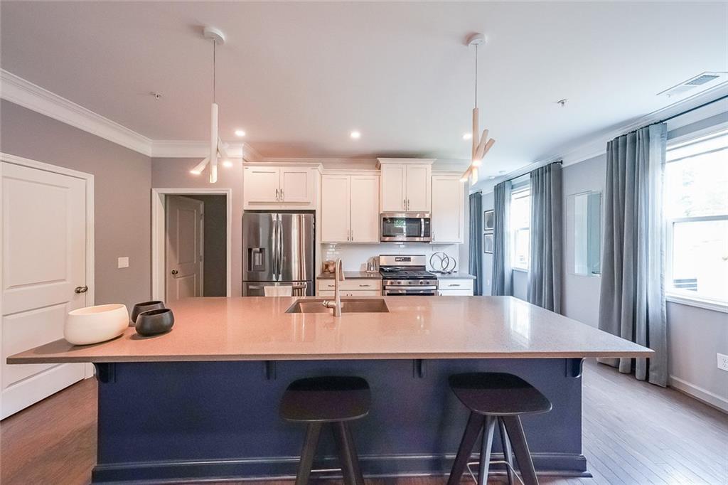 1024 Rohner Way Smyrna, GA 30080 - Photo 6 of 17 a kitchen with kitchen island a sink appliances and a window