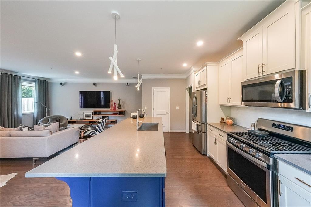 1024 Rohner Way Smyrna, GA 30080 - Photo 7 of 17 a large kitchen with sink a microwave a stove and refrigerator