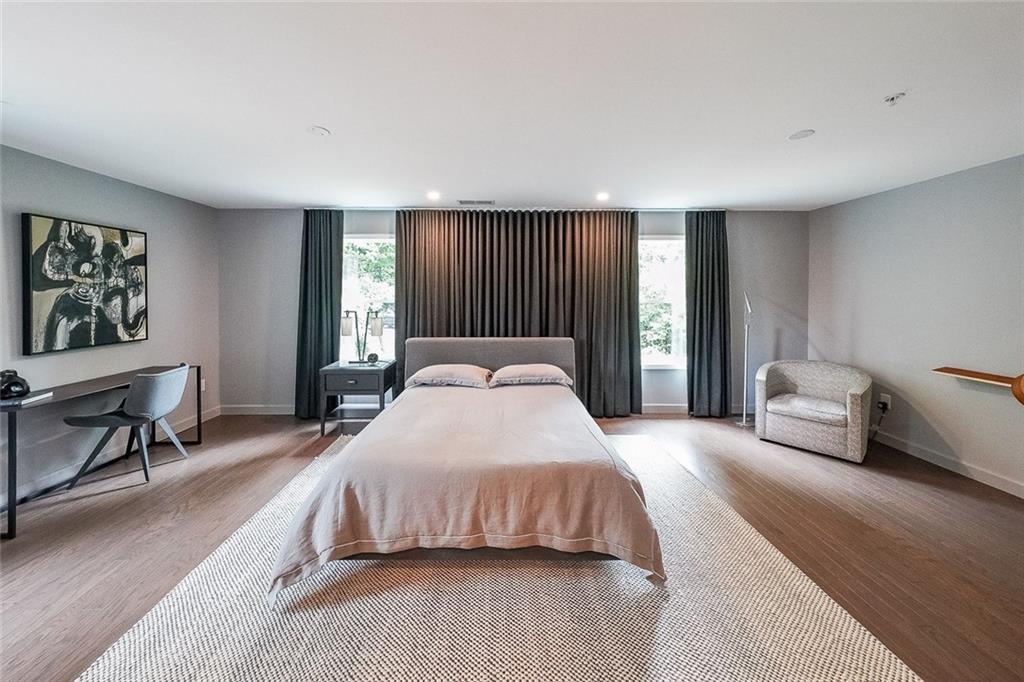 1024 Rohner Way Smyrna, GA 30080 - Photo 8 of 17 a spacious bedroom with a bed a table and a dresser