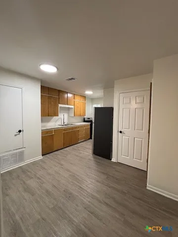 a view of kitchen with wooden floor