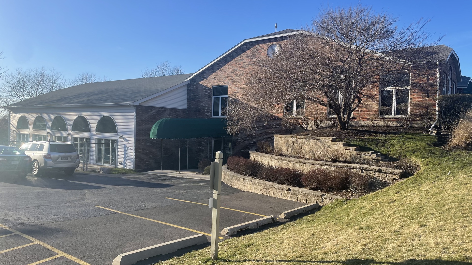 4301 West Shamrock Lane, Unit 2D McHenry, IL 60050 - Photo 12 of 18 a view of a white house with a patio