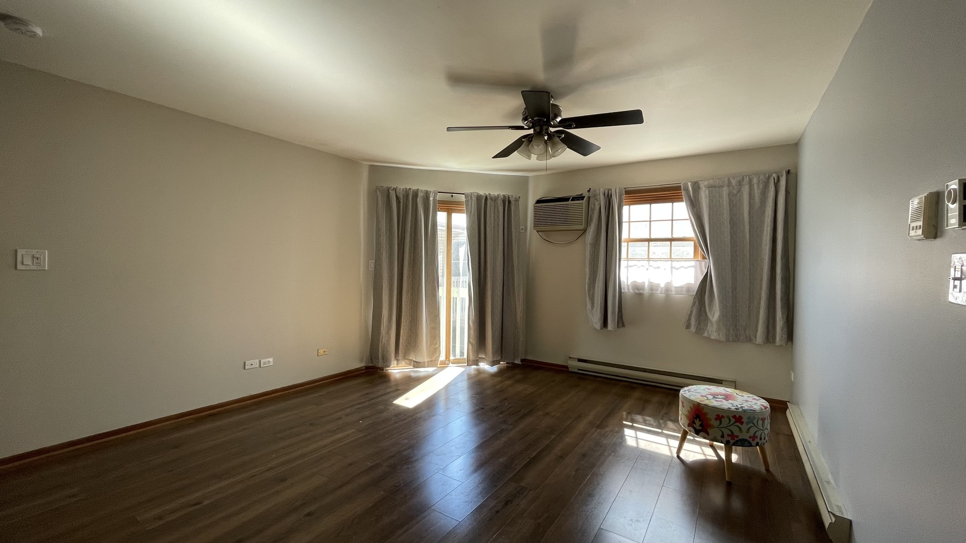 4301 West Shamrock Lane, Unit 2D McHenry, IL 60050 - Photo 3 of 18 a view of a livingroom with wooden floor and a ceiling fan