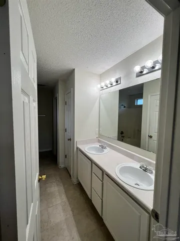a bathroom with a double vanity sink and mirror