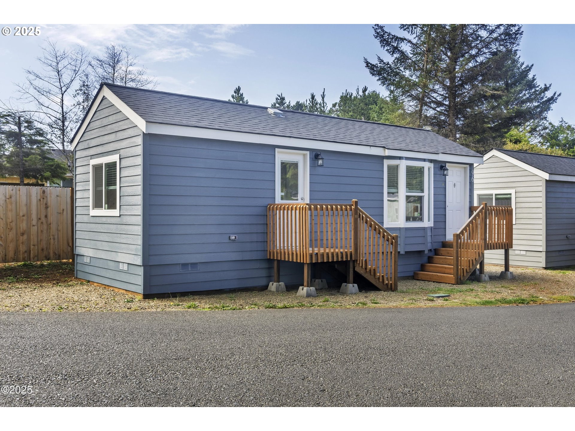 4875 Highway 101, Unit 96 Depoe Bay, OR 97341 - Photo 12 of 18 a view of a house with a yard and wooden fence