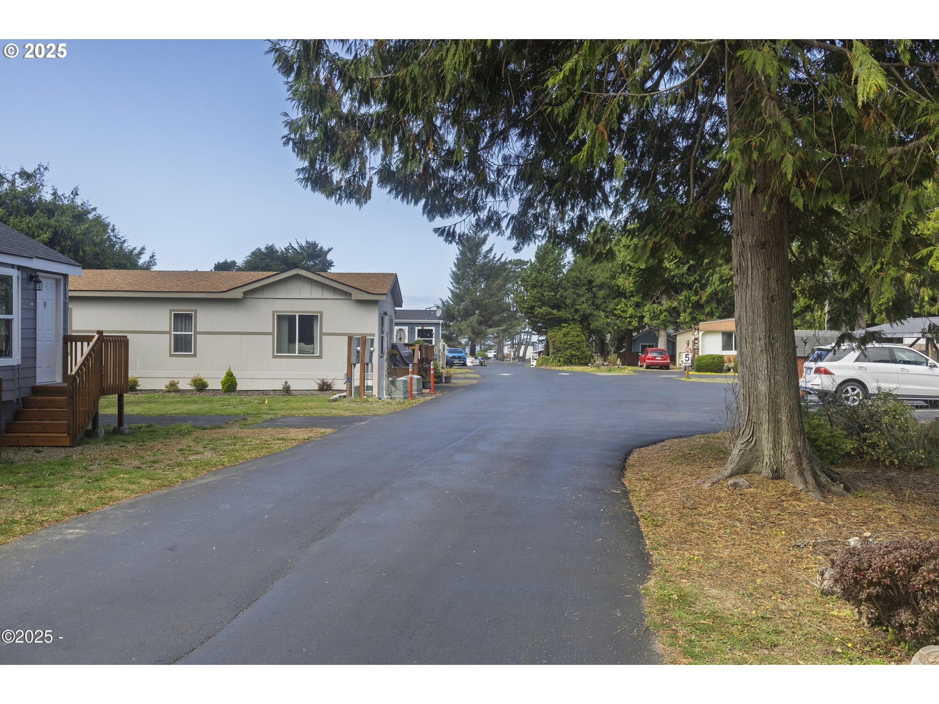 4875 Highway 101, Unit 96 Depoe Bay, OR 97341 - Photo 13 of 18 a view of a house with backyard and tree
