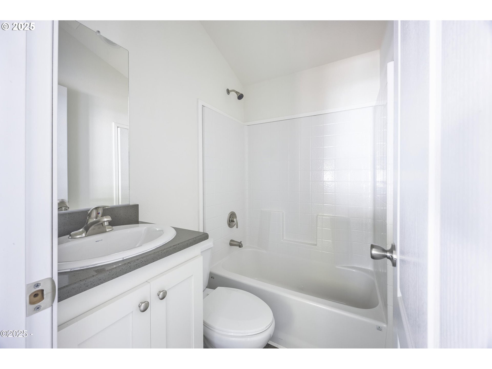4875 Highway 101, Unit 96 Depoe Bay, OR 97341 - Photo 10 of 18 a bathroom with a sink a toilet a mirror and shower