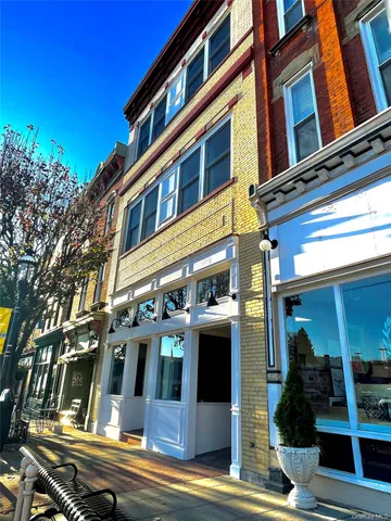 a view of a hallway and a livingroom with furniture