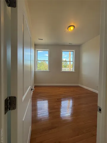 a view of room with hardwood floor and window