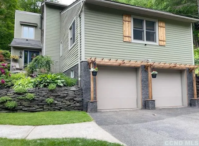 a front view of a house with garden