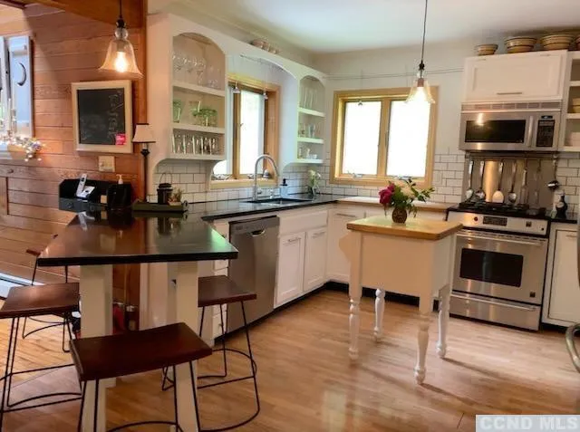 a kitchen with a stove a sink and a microwave