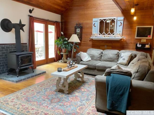 1325 County Rte 27 Craryville, NY 12521 - Photo 17 of 35 a living room with furniture a flat screen tv and a floor to ceiling window