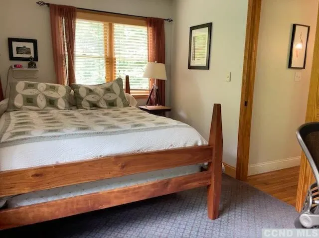 a bedroom with a bed and a window