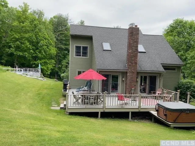 a view of a house with a backyard and a small pool
