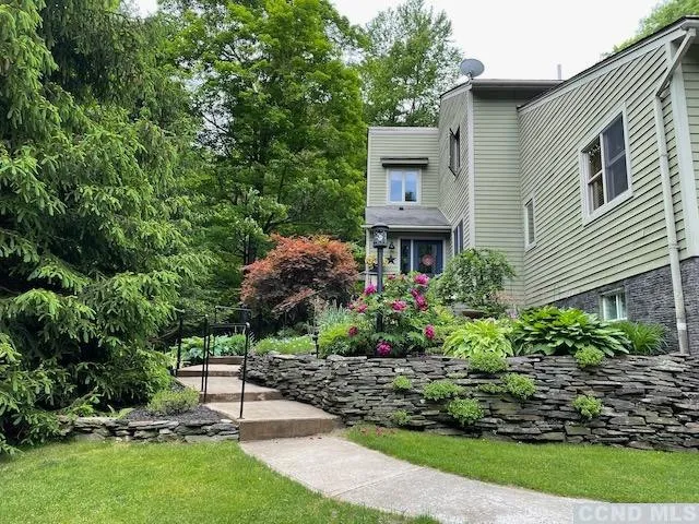 a view of a chair and table in backyard of the house