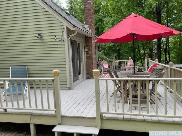 a view of a patio with a table and chairs under an umbrella