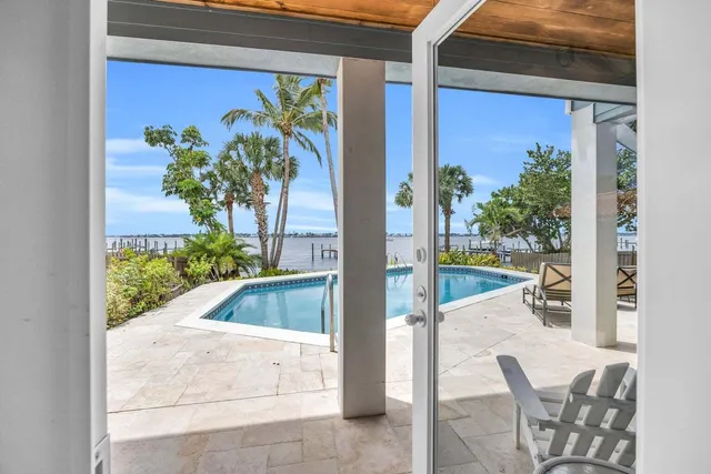 a view of a balcony with furniture and front door