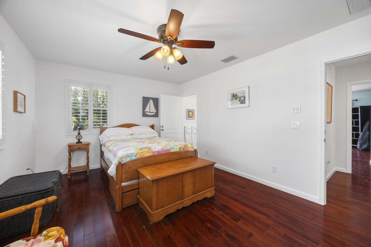 1009 Northwest Terrace Road Stuart, FL 34994 - Photo 39 of 69 a bedroom with a bed and wooden floor