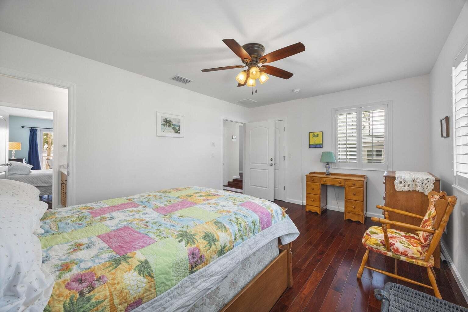 1009 Northwest Terrace Road Stuart, FL 34994 - Photo 40 of 69 a bedroom with a bed and wooden floor