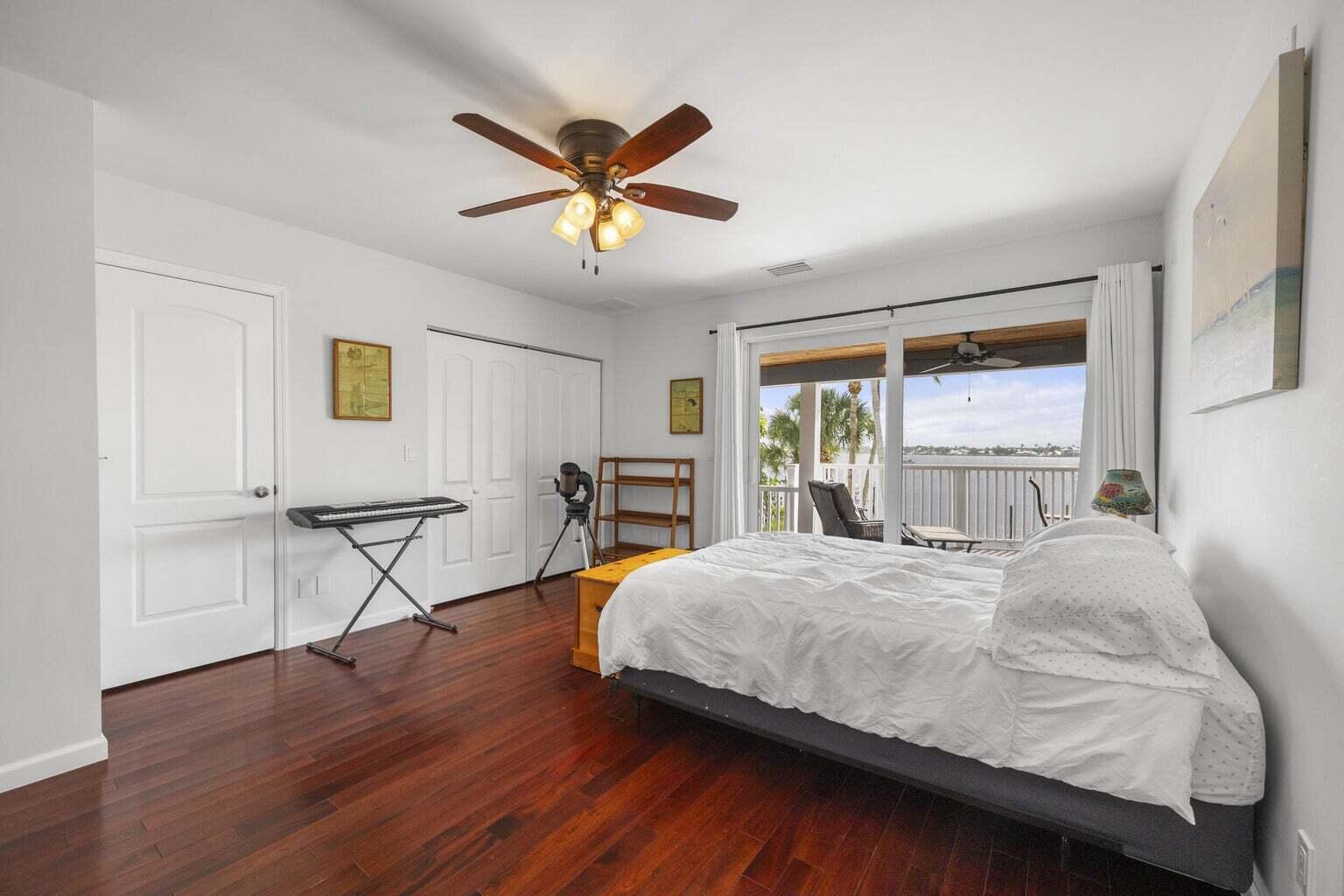 1009 Northwest Terrace Road Stuart, FL 34994 - Photo 41 of 69 a bedroom with a bed and a chandelier