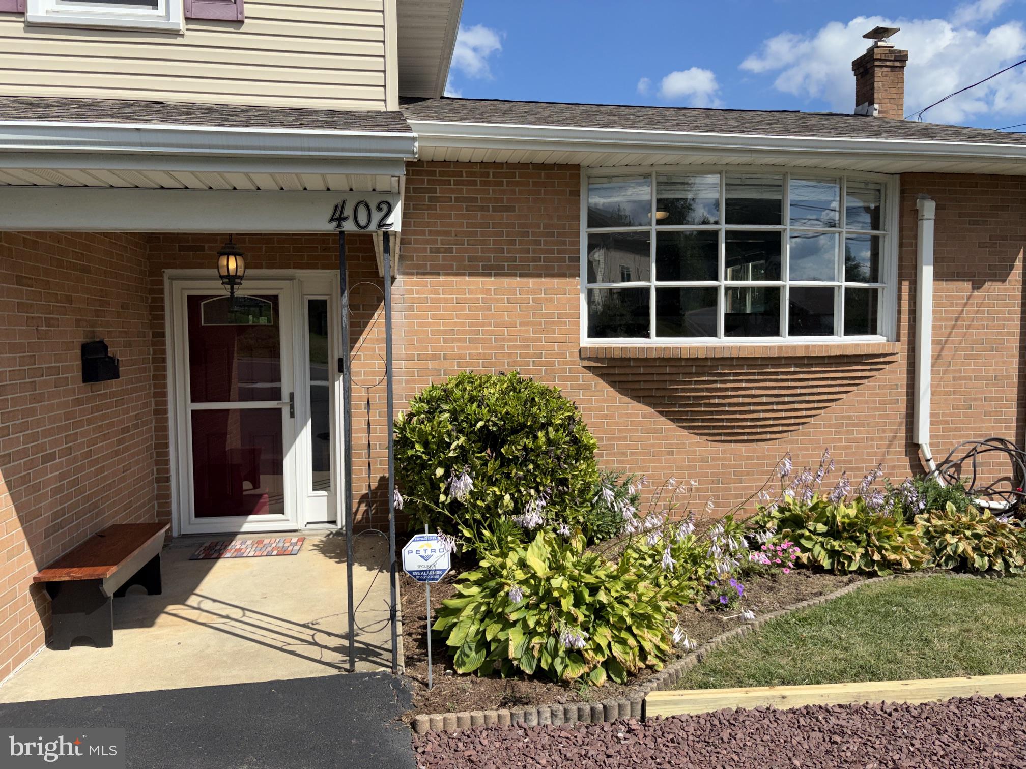 402 Grosstown Road Stowe, PA 19464 - Photo 3 of 37 Charming entrance with vibrant blooms.