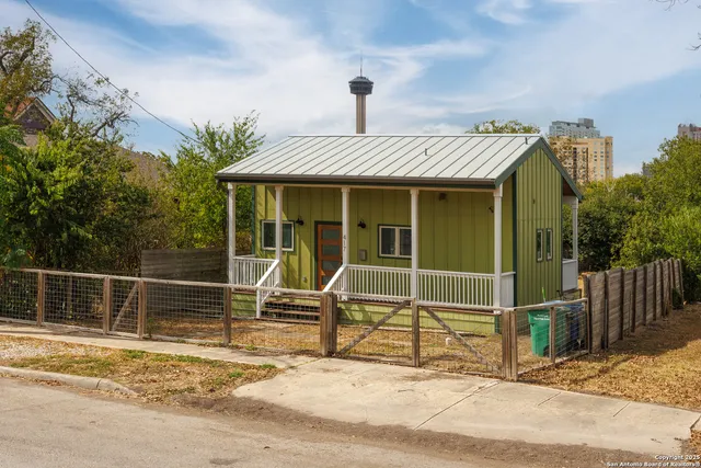 a view of a house with a wooden floor and fence