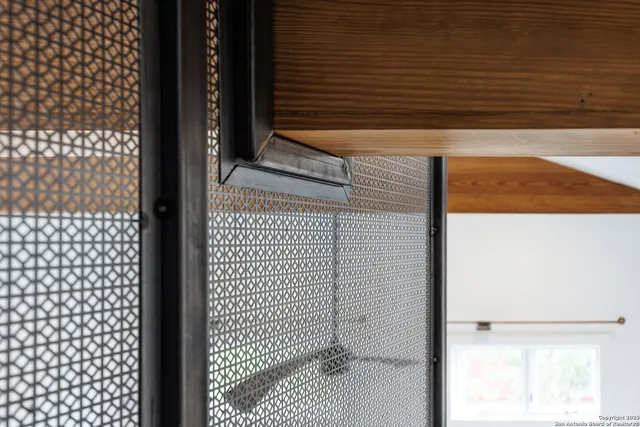 a view of a balcony with chairs and wooden floor