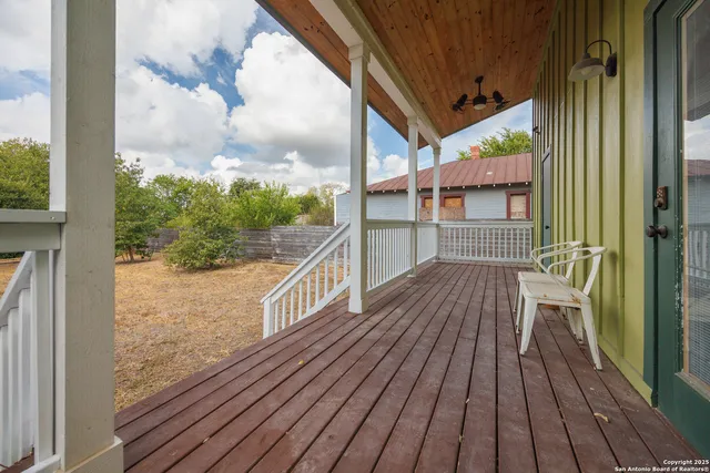 a view of a white house with a yard and sitting area