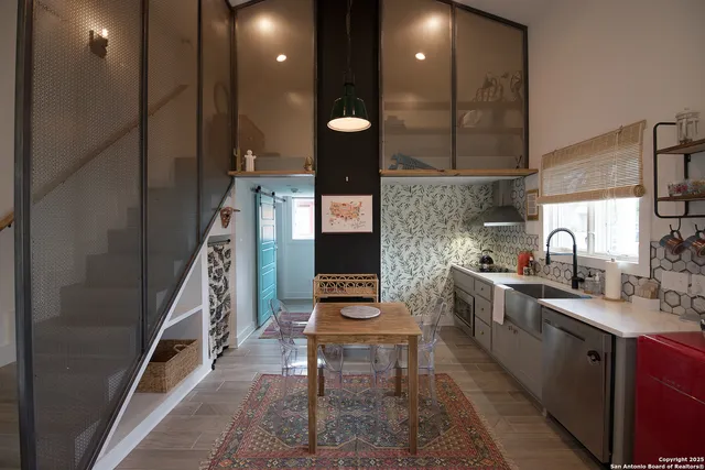 a kitchen with a sink stainless steel appliances and cabinets