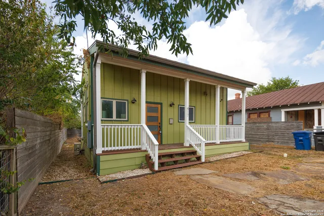 a view of a house with backyard porch and sitting area