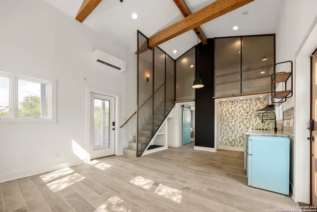 a view of a livingroom with furniture and staircase