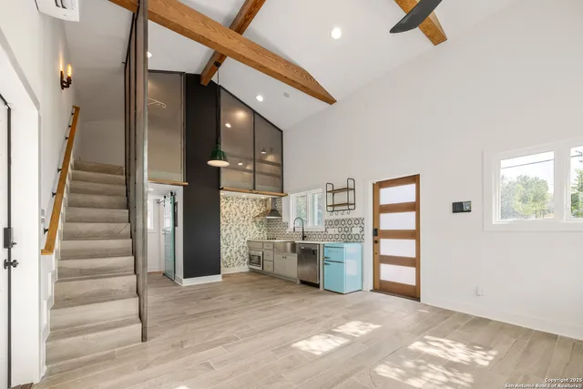 a view of kitchen and hall with wooden floor