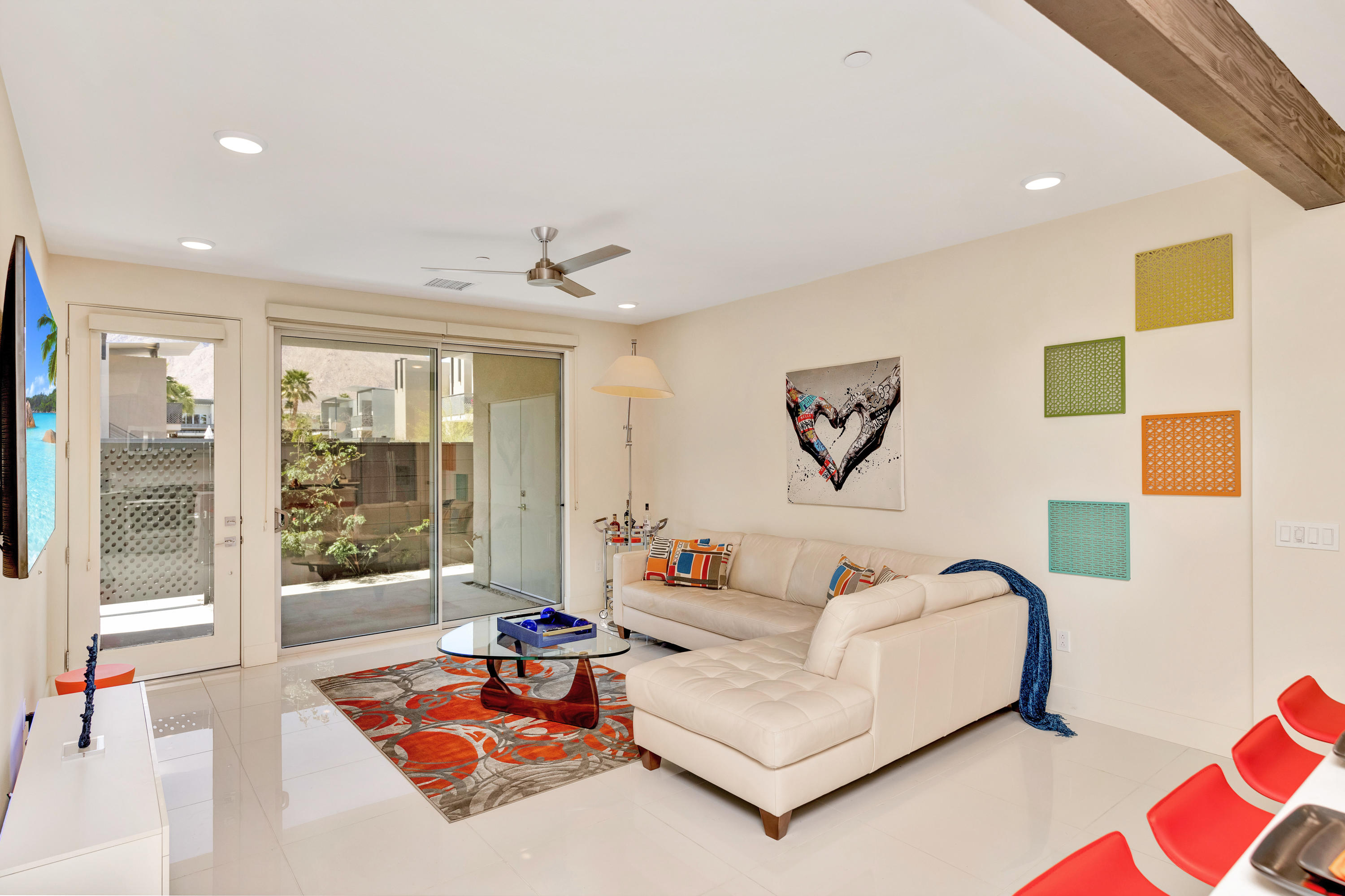 a living room with furniture and a floor to ceiling window