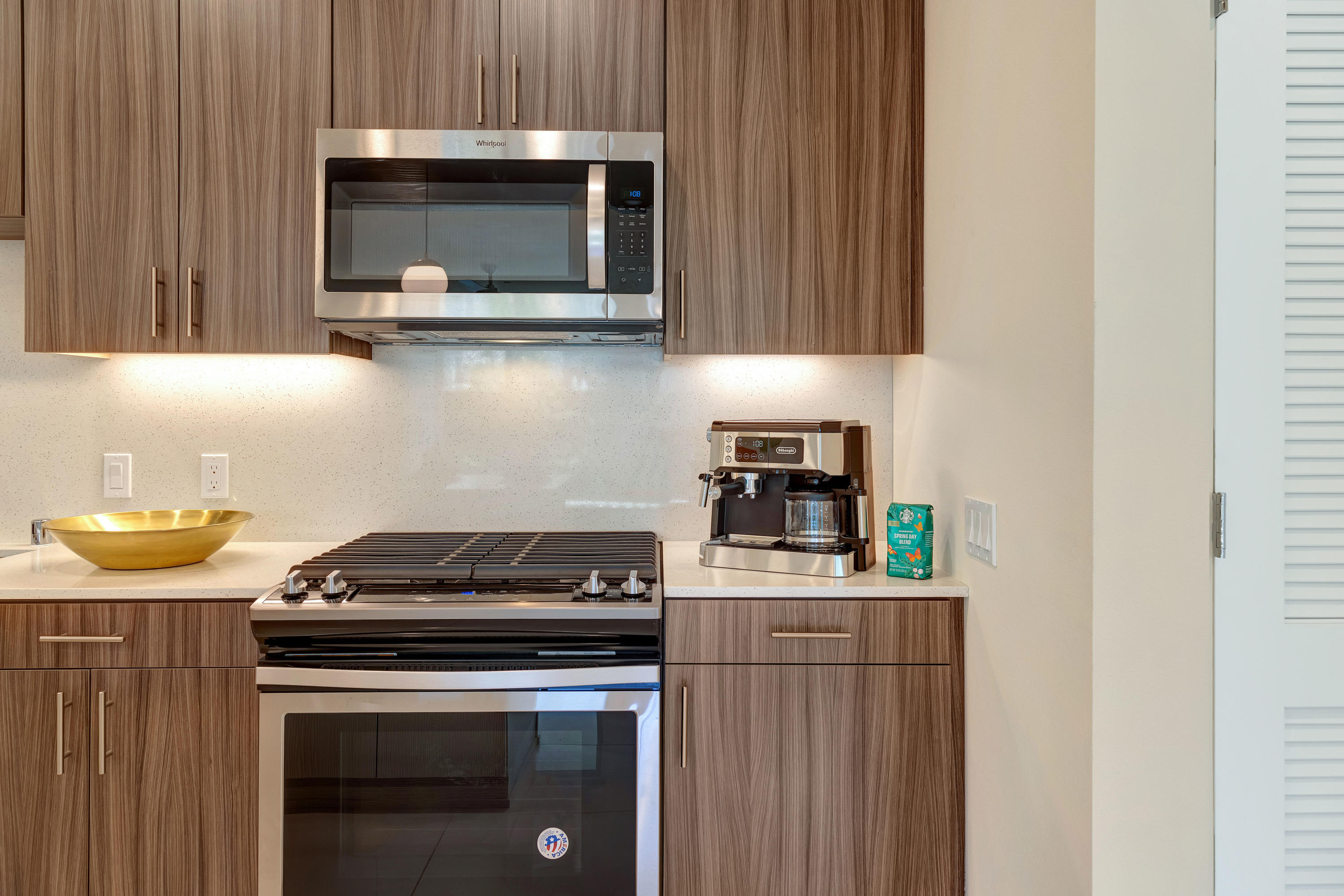 161 The River Palm Springs, CA 92262 - Photo 21 of 46 a kitchen with stainless steel appliances a stove a microwave a sink and cabinets