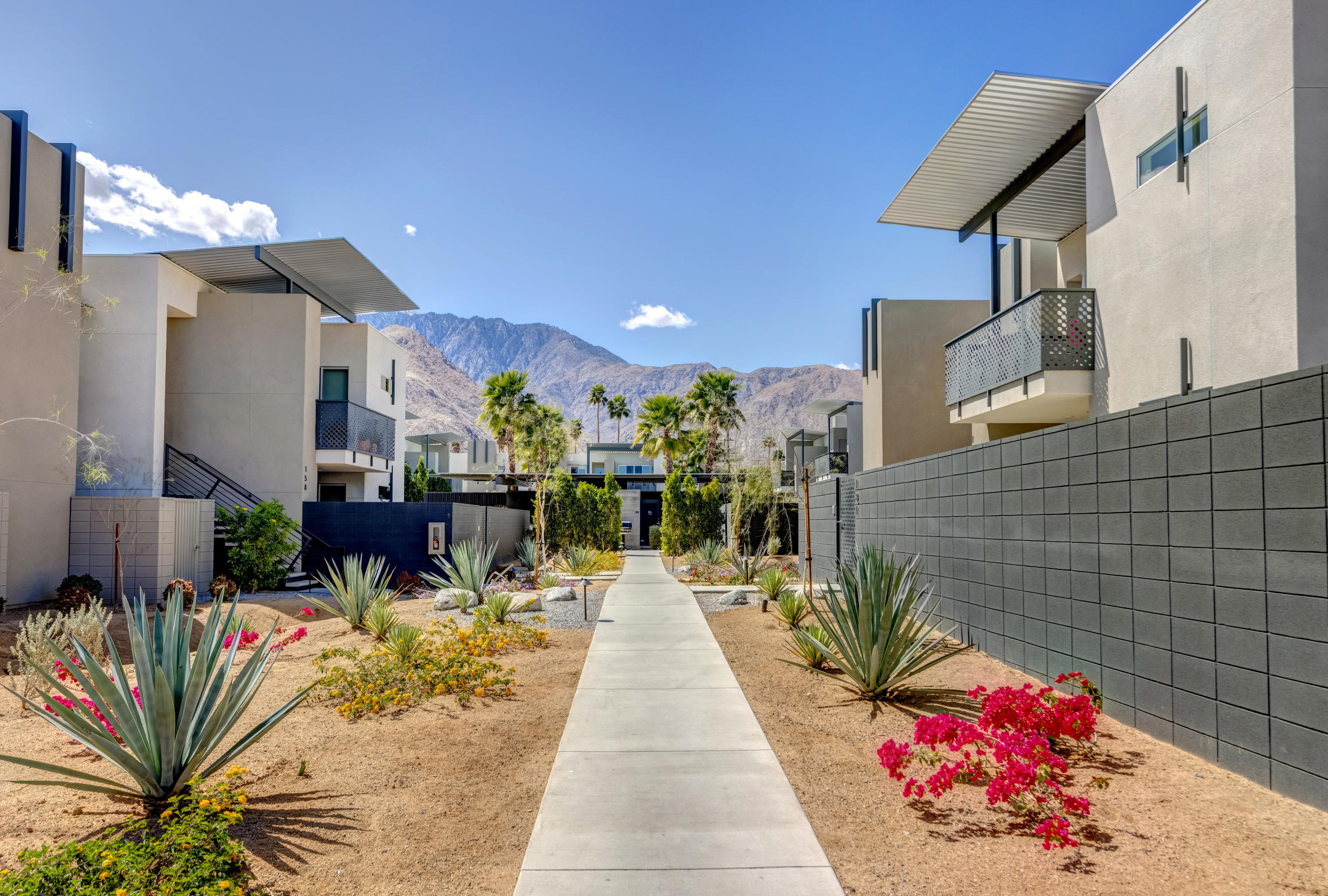 161 The River Palm Springs, CA 92262 - Photo 42 of 46 a view of a patio with dining table and chairs with potted plants