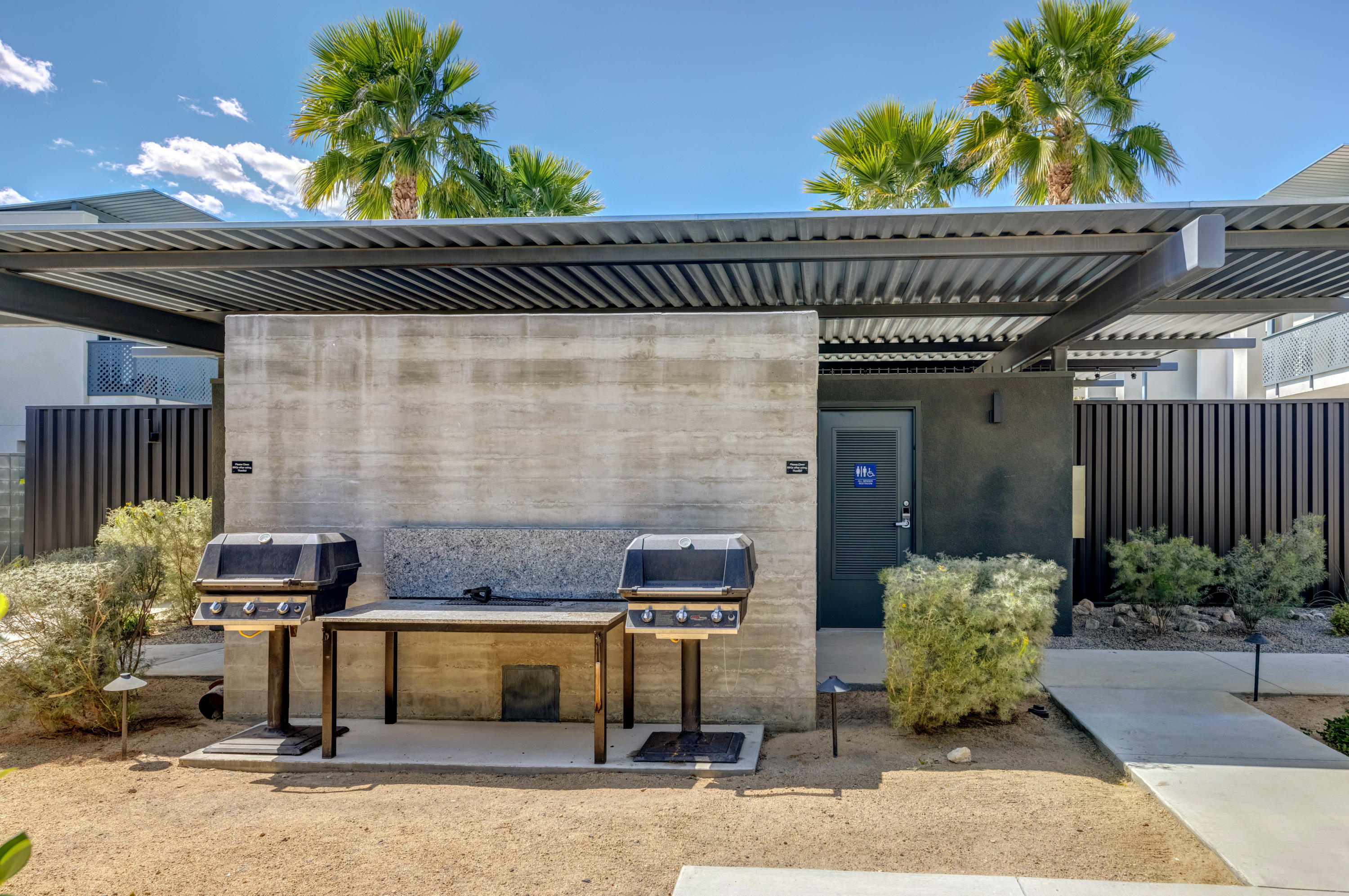 161 The River Palm Springs, CA 92262 - Photo 43 of 46 a backyard of a house with table and chairs