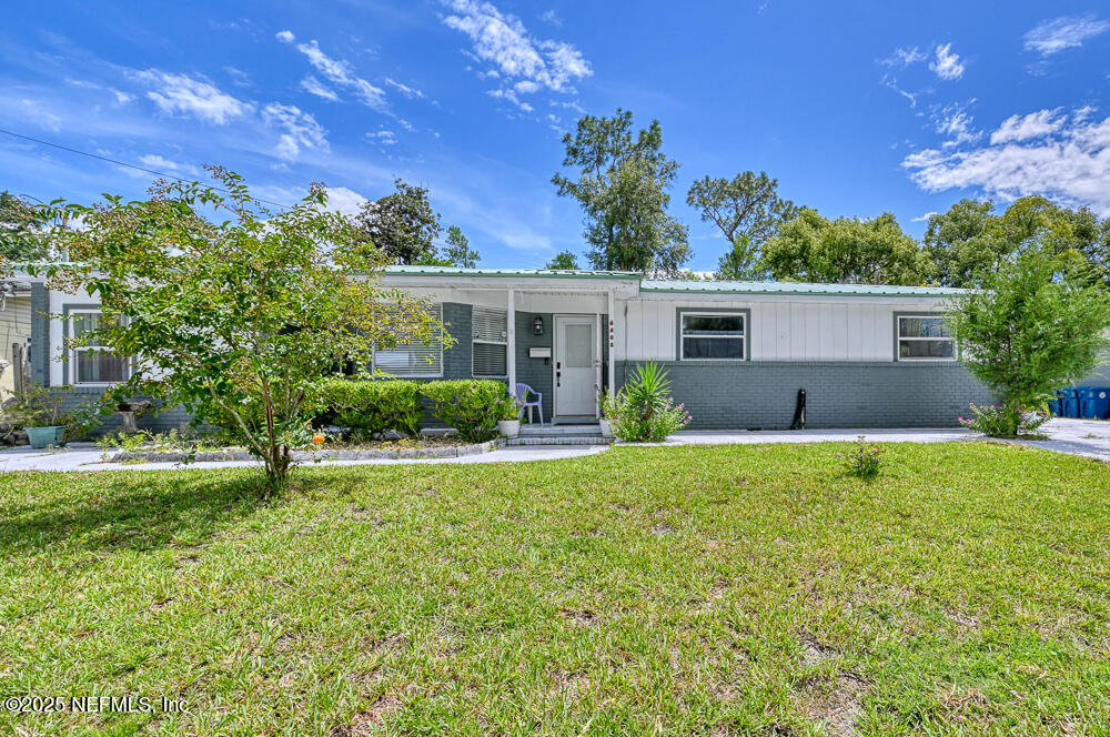 a front view of house with yard and green space