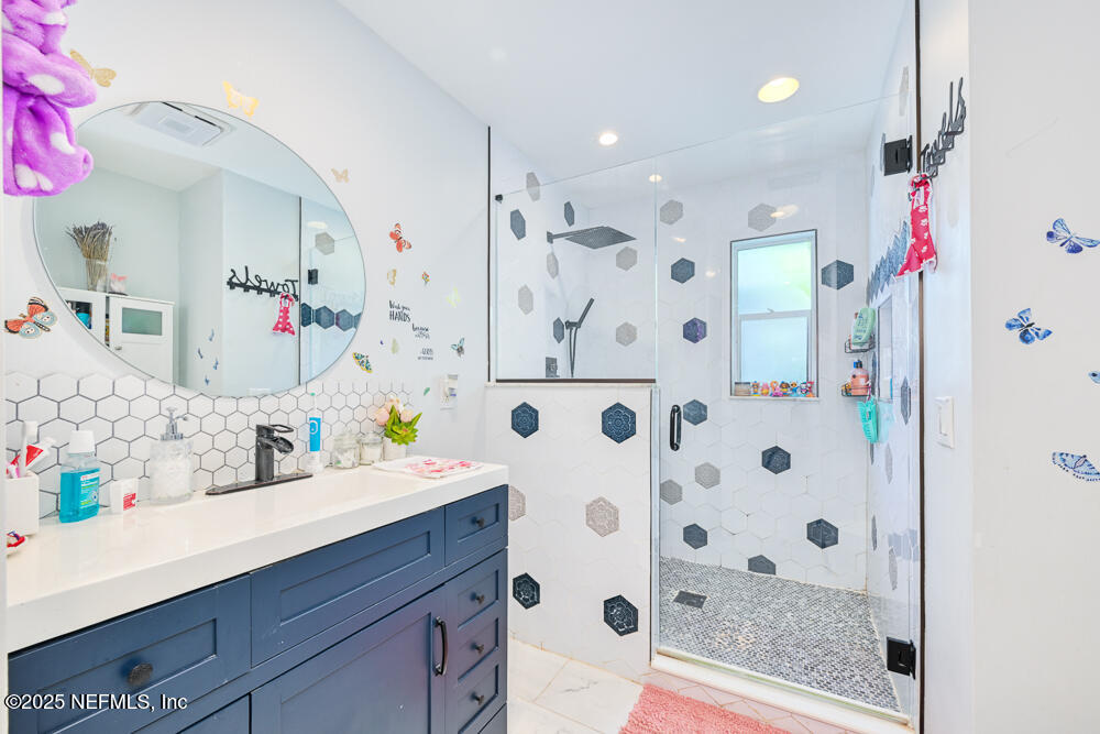 6408 Diane Road Jacksonville, FL 32277 - Photo 15 of 30 a bathroom with a sink and a mirror