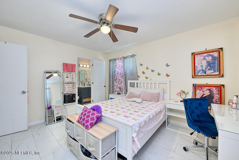 6408 Diane Road Jacksonville, FL 32277 - Photo 17 of 30 a bedroom with a bed a couch and dresser