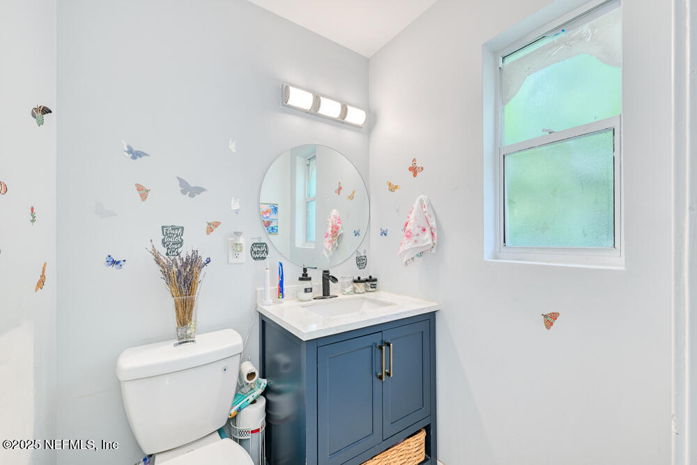 6408 Diane Road Jacksonville, FL 32277 - Photo 18 of 30 a bathroom with a sink mirror and toilet