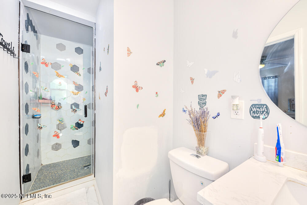 6408 Diane Road Jacksonville, FL 32277 - Photo 19 of 30 a white toilet sitting next to a bathroom sink