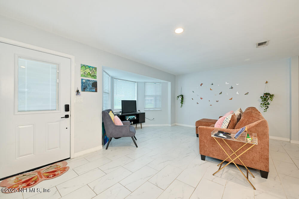 6408 Diane Road Jacksonville, FL 32277 - Photo 6 of 30 a living room with furniture a rug and a window