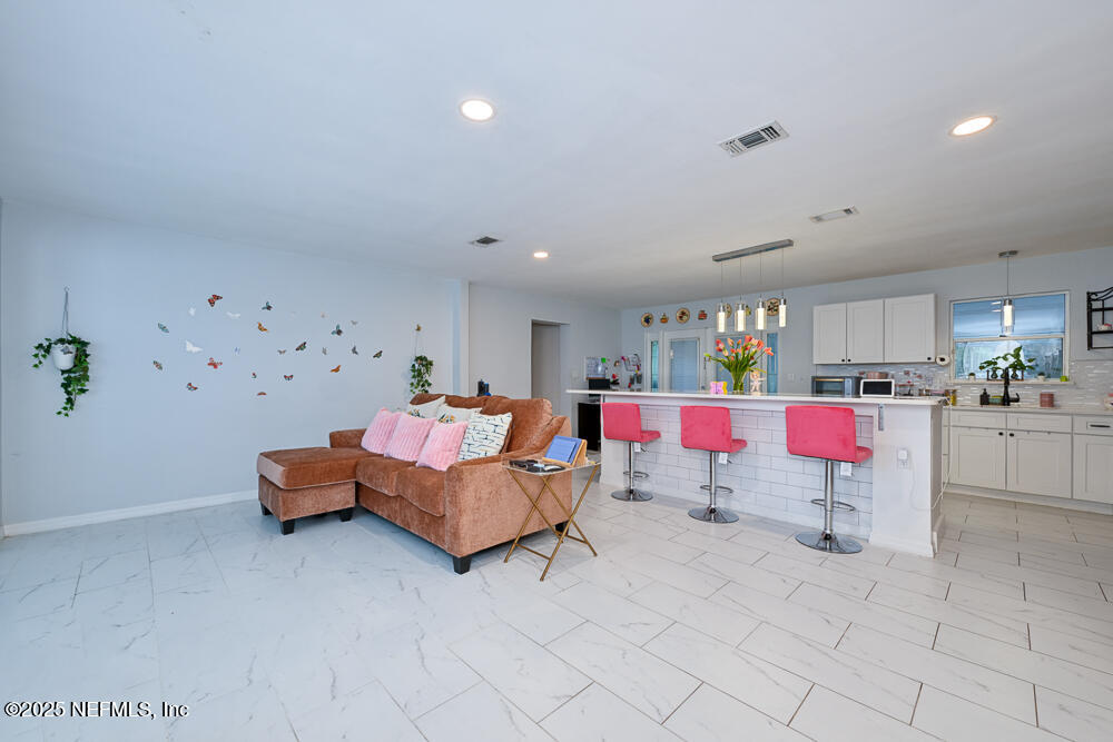 6408 Diane Road Jacksonville, FL 32277 - Photo 7 of 30 a living room with furniture and kitchen view