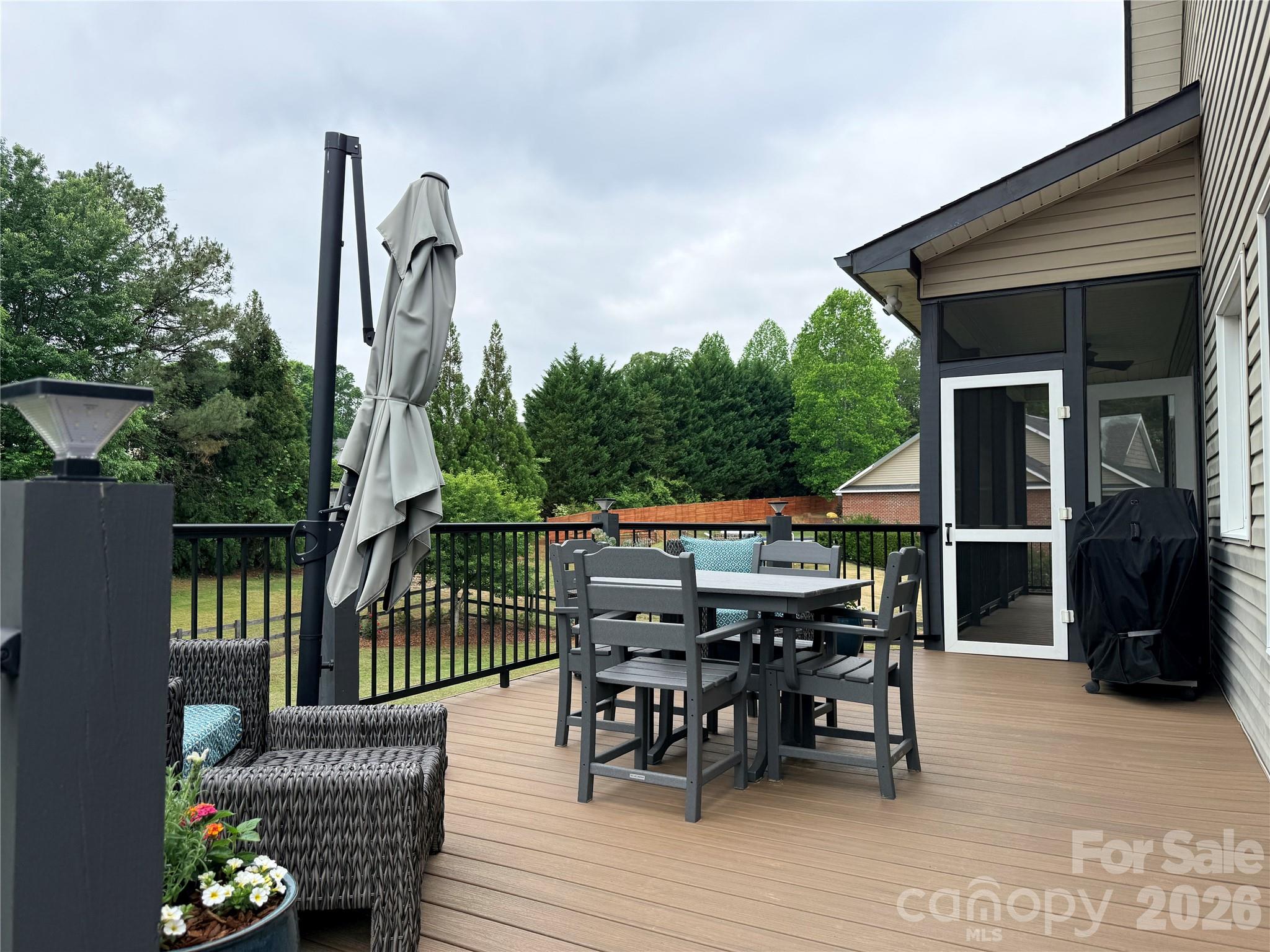 183 Burl Bridges Road Forest City, NC 28043 - Photo 29 of 33 a view of a roof deck with table and chairs and wooden floor