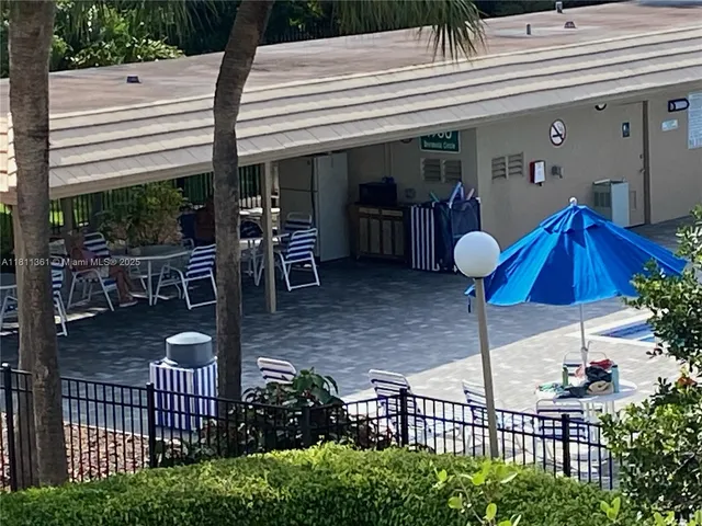a view of a porch with chairs and potted plants